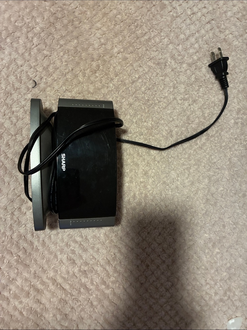 Sharp Black Compact Electronic Accessory with Power Cord